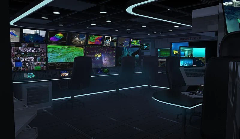 a room with a row of computer screens and a table with chairs aboard OCEANXPLORER 1 Yacht for Sale
