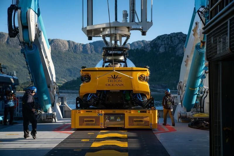 a yellow vehicle on a road aboard OCEANXPLORER 1 Yacht for Sale