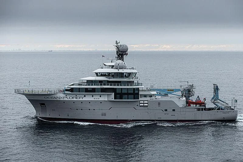 a large white ship in the water aboard OCEANXPLORER 1 Yacht for Sale