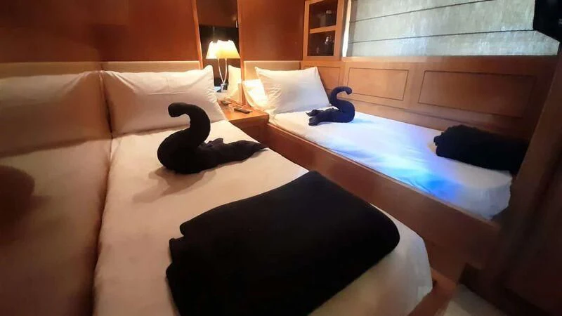 a black cat on a bed aboard PALOMA Yacht for Sale