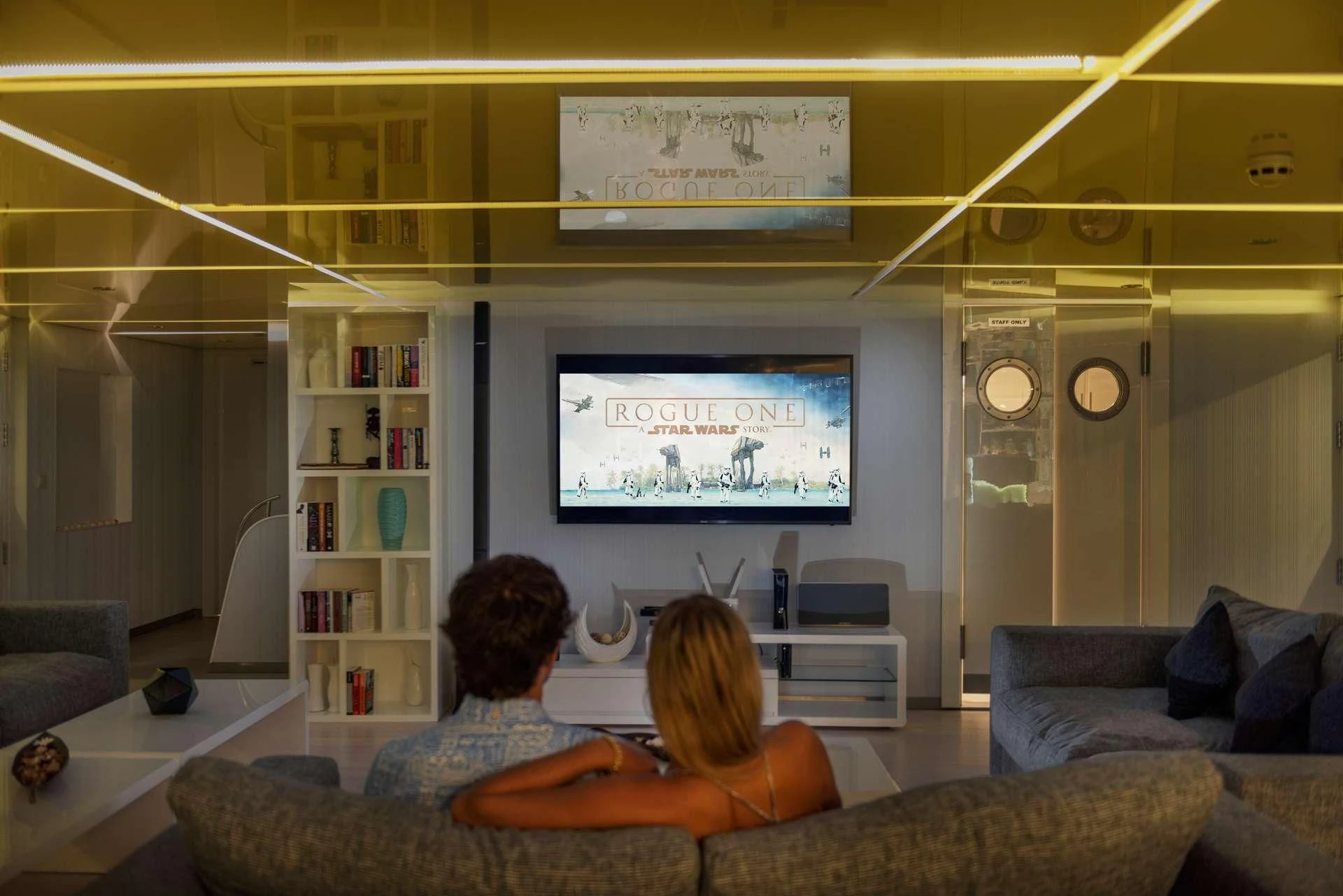 a person and a child watching a television in a room aboard SEAREX Yacht for Sale
