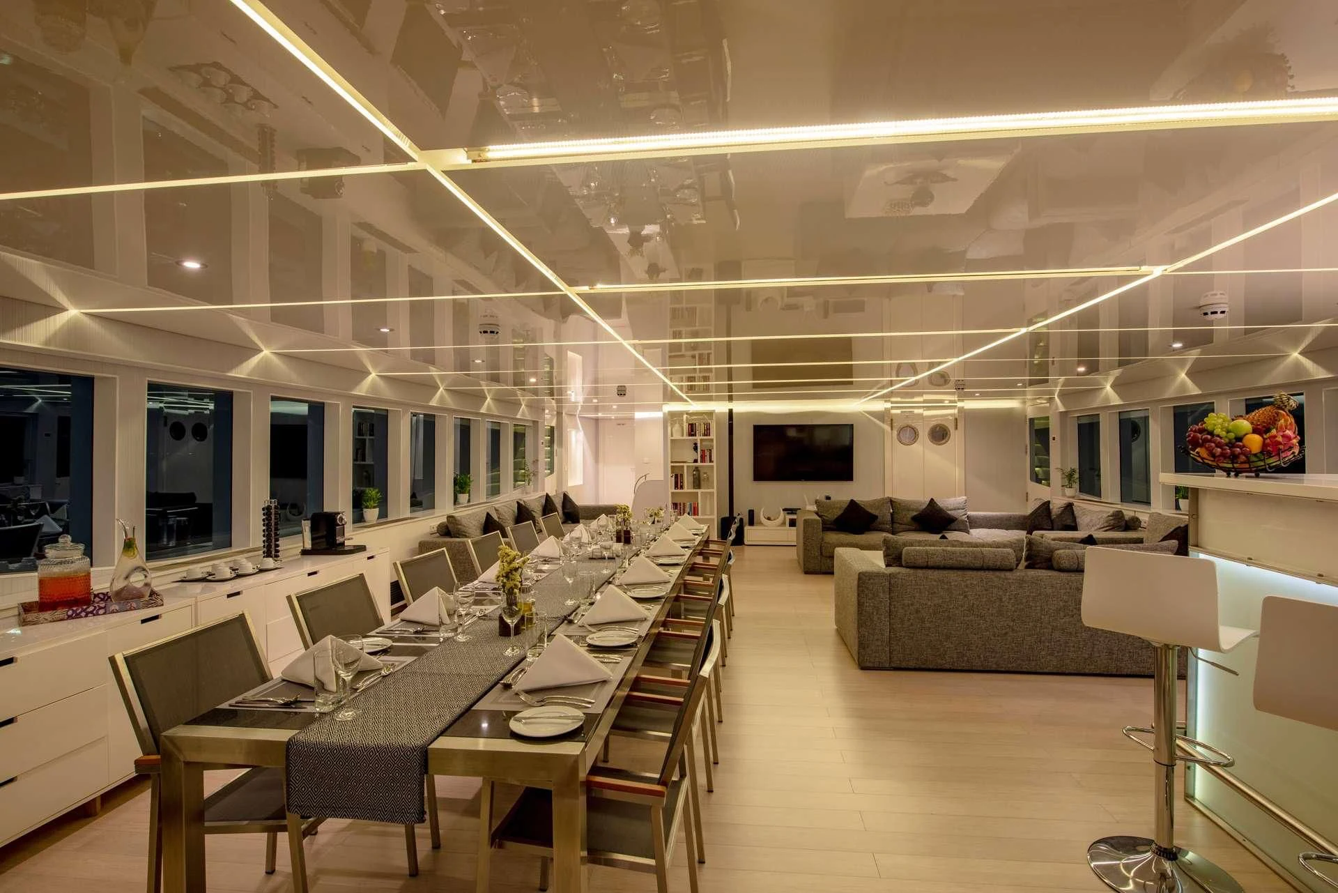 a large room with tables and chairs aboard SEAREX Yacht for Sale