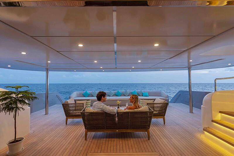 a group of people sitting on a couch by a pool aboard SEAREX Yacht for Sale