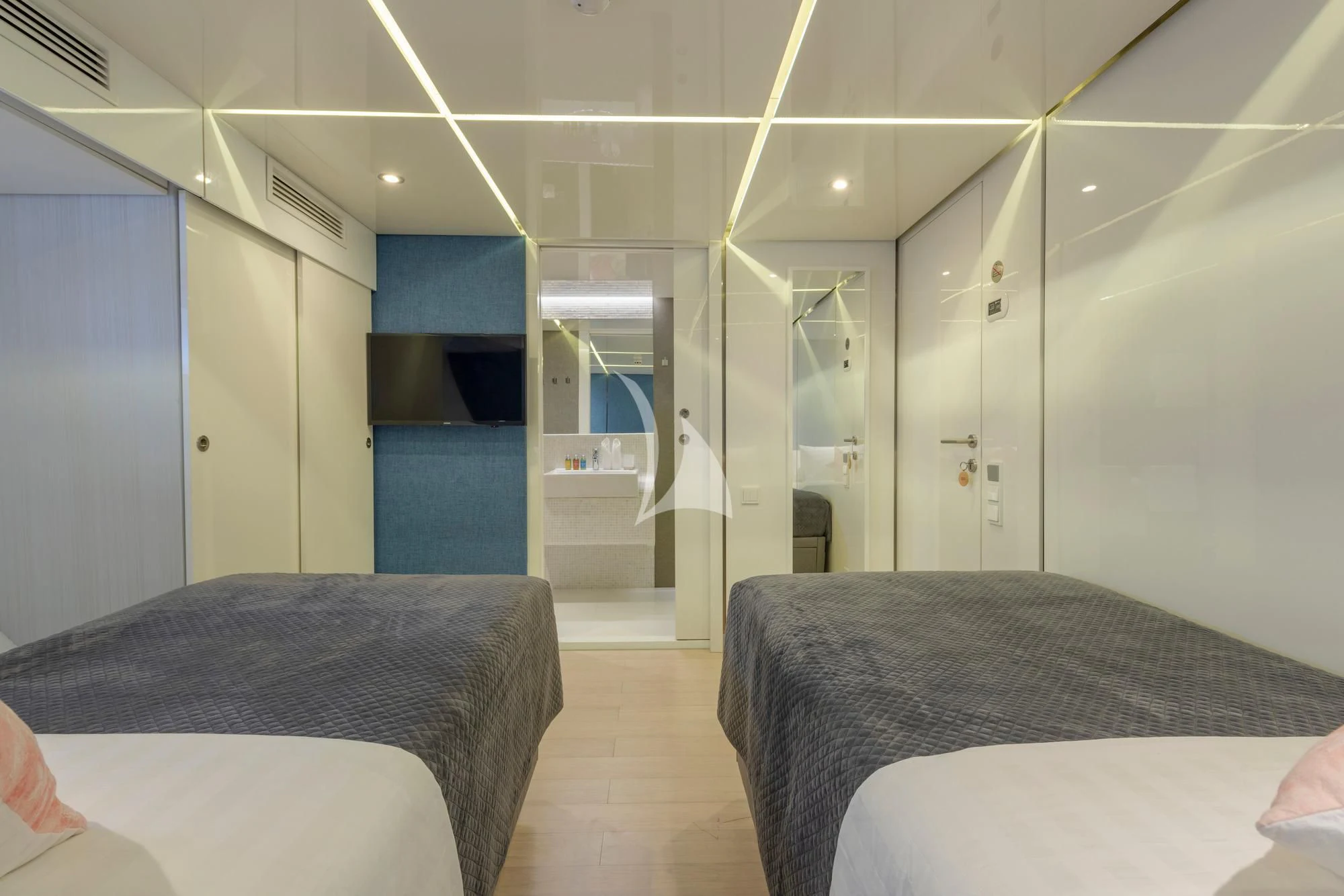 a room with beds and a door aboard SEAREX Yacht for Sale