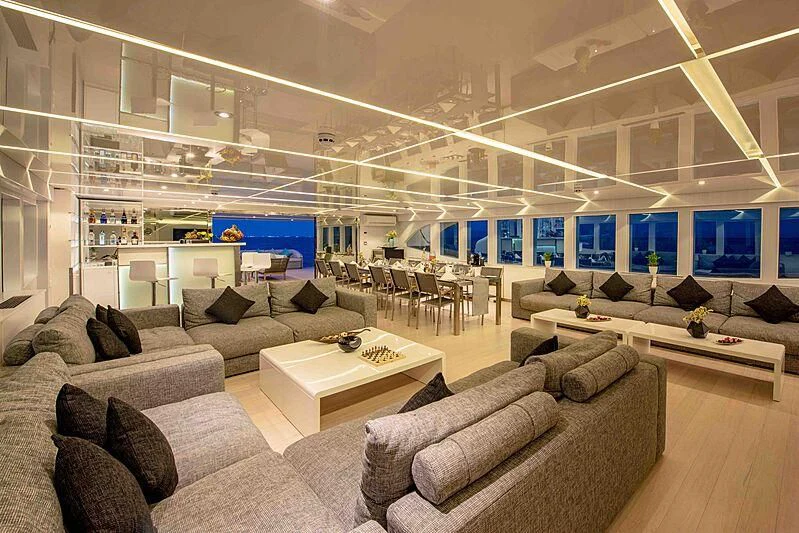 a large room with couches and a table aboard SEAREX Yacht for Sale