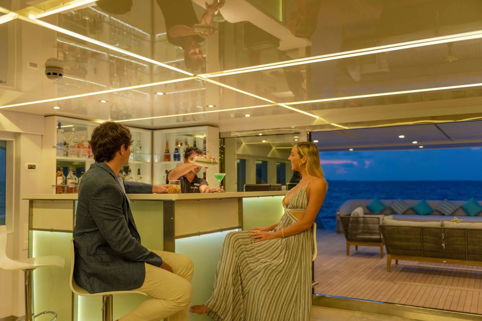 a man and a woman sitting at a table in a room aboard SEAREX Yacht for Sale