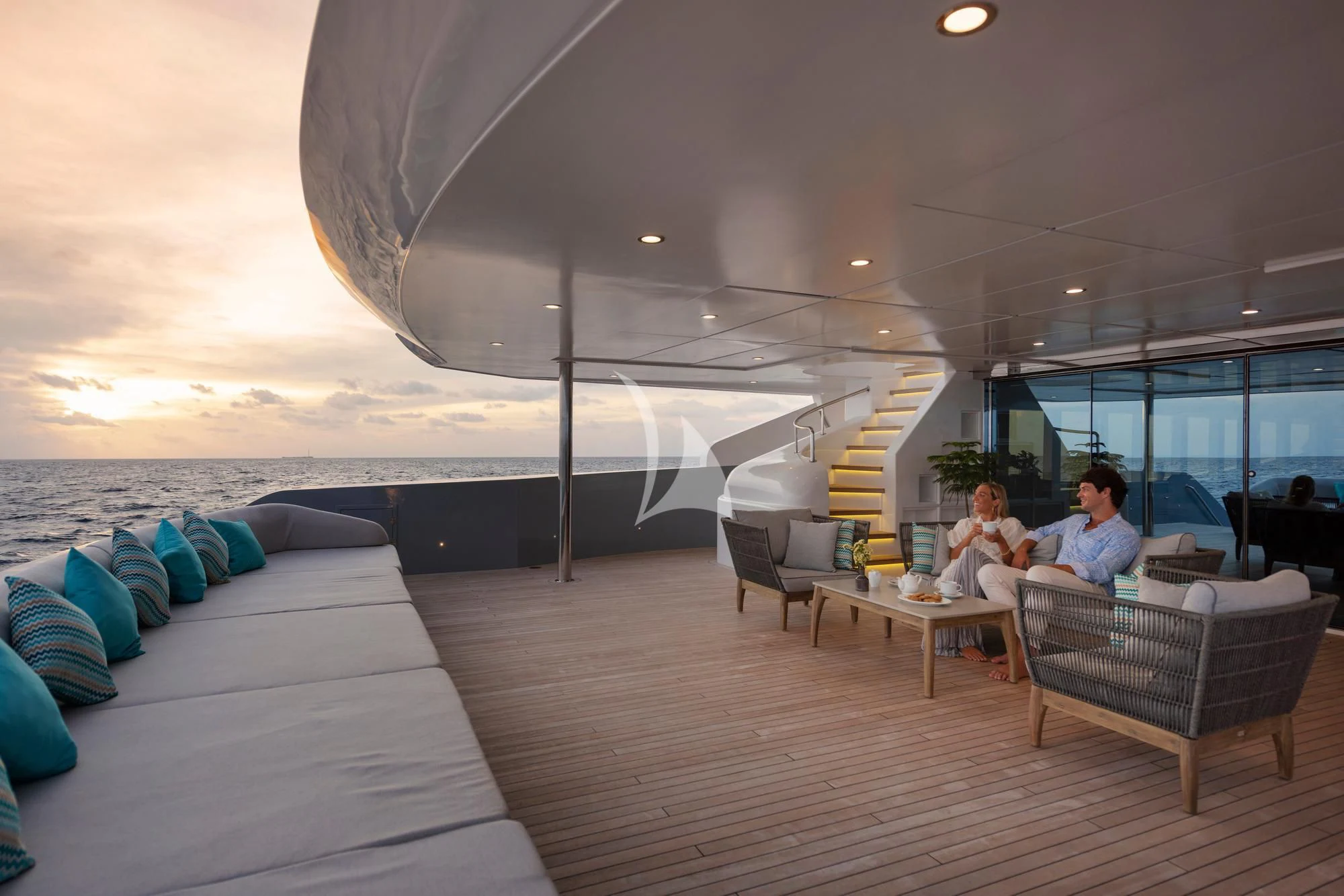 a couple sitting on a couch aboard SEAREX Yacht for Sale