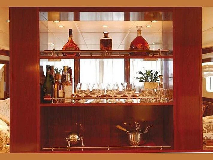 a glass shelf with bottles and glasses aboard DADDY SHANE Yacht for Sale