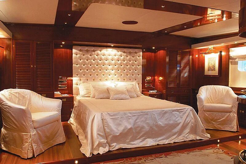 a room with a bed and a chair aboard DADDY SHANE Yacht for Sale