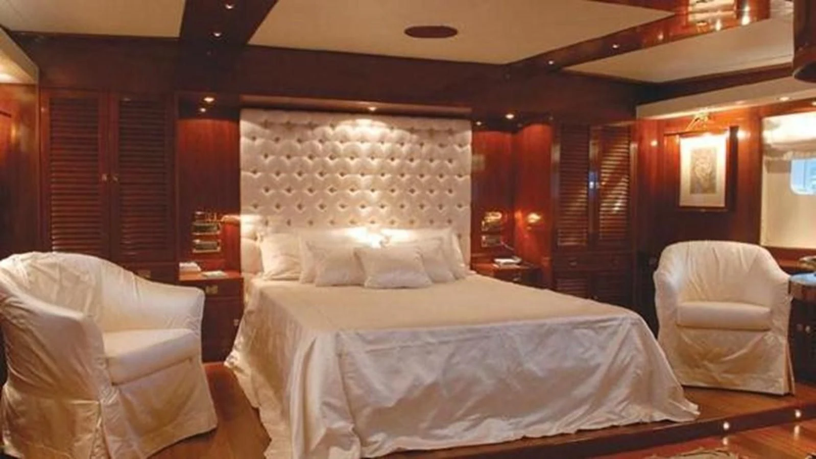 a room with a bed and a chair aboard DADDY SHANE Yacht for Sale