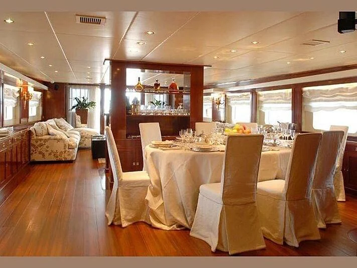a room with tables and chairs aboard DADDY SHANE Yacht for Sale