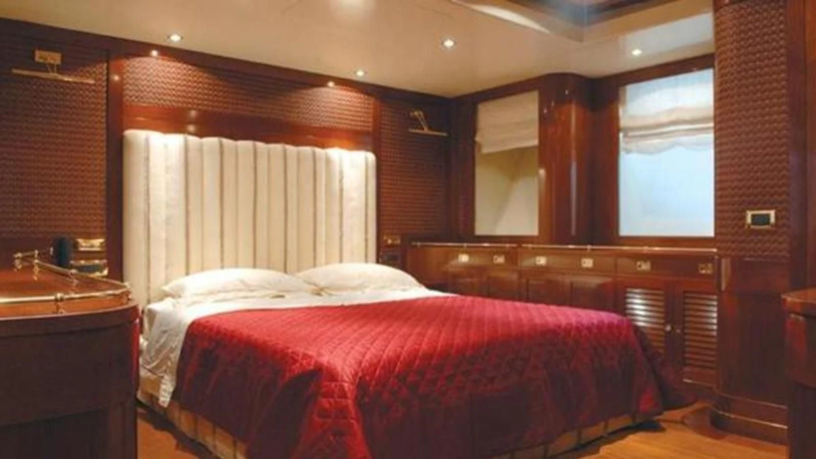 a room with a bed and a window aboard DADDY SHANE Yacht for Sale