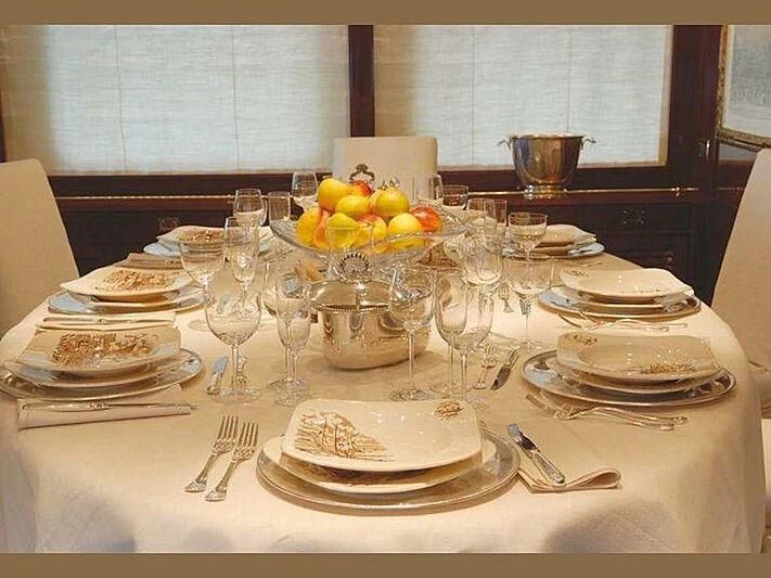 a table with plates and glasses aboard DADDY SHANE Yacht for Sale