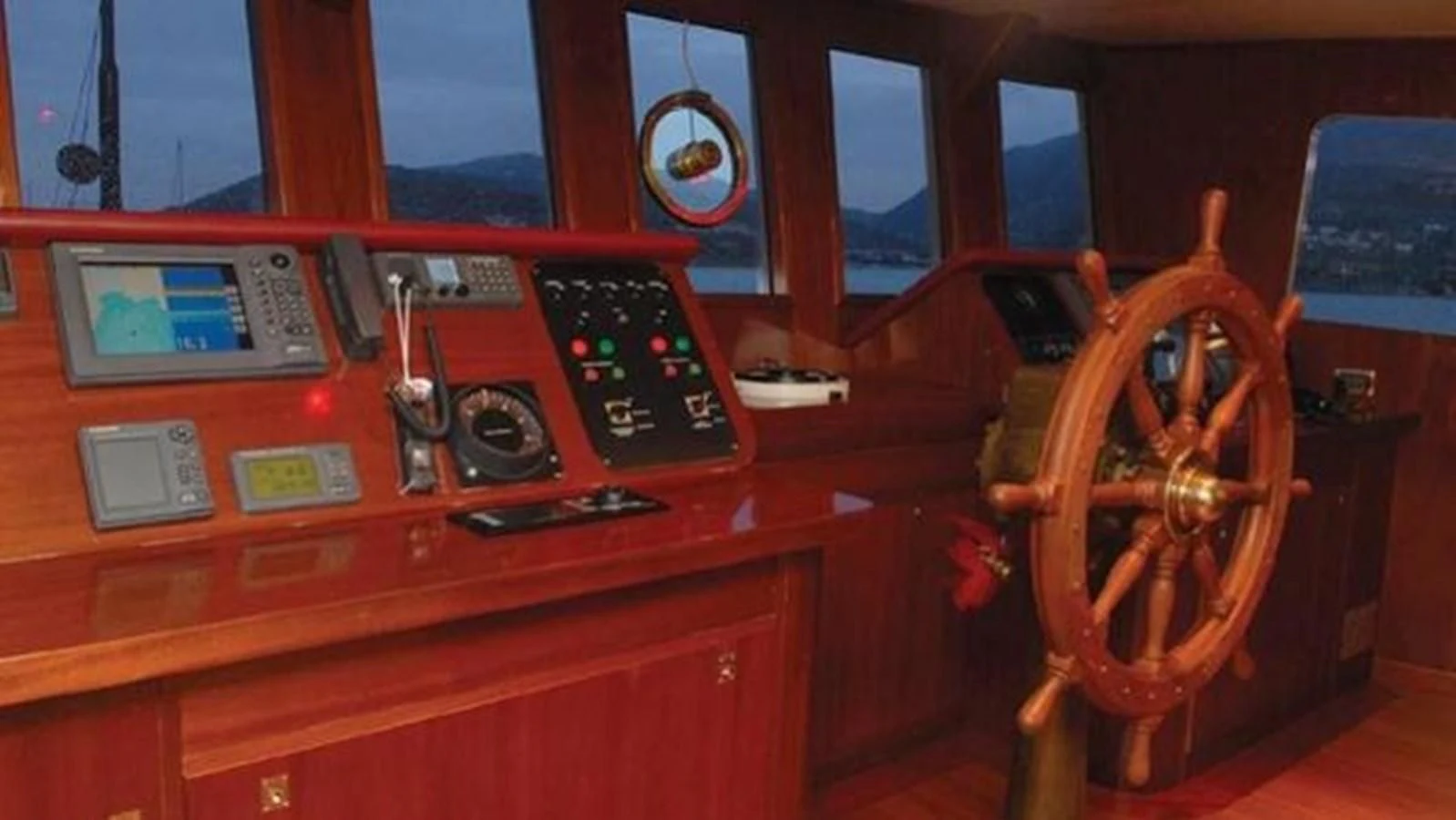 a wooden desk with a computer and a radio aboard DADDY SHANE Yacht for Sale
