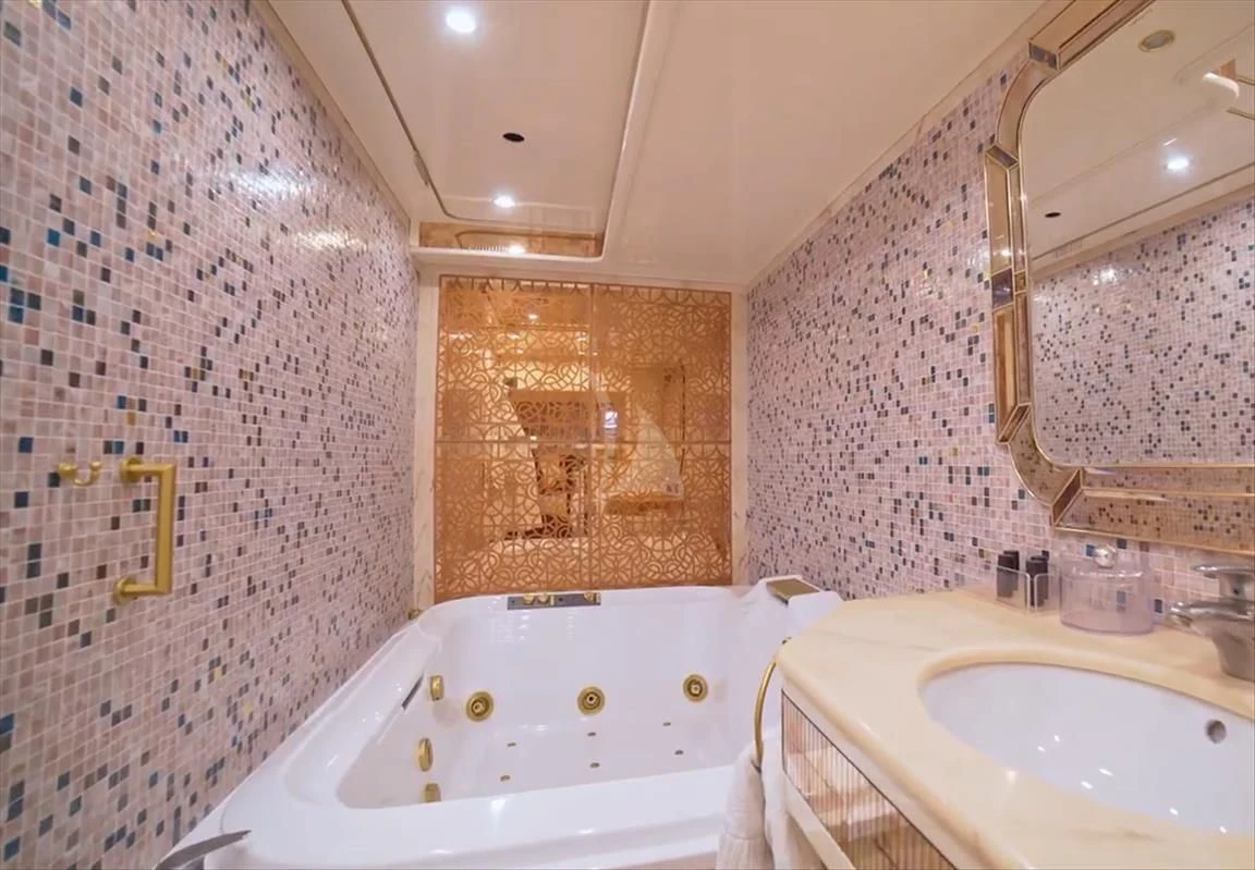 a bathroom with a bathtub and sink aboard WISH Yacht for Sale