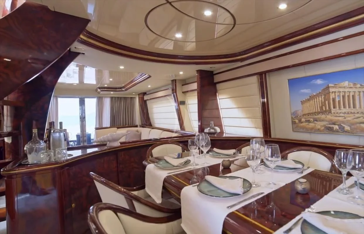 a dining room with a table set aboard WISH Yacht for Sale