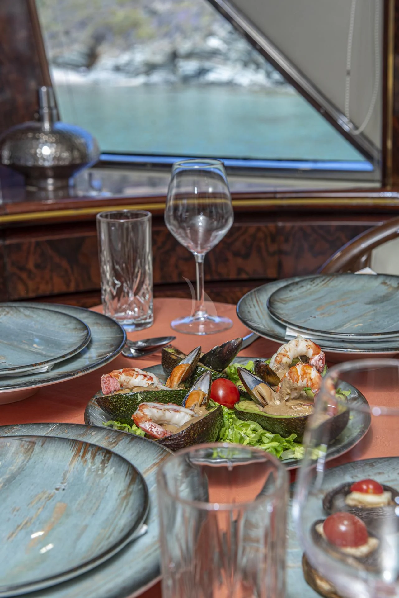 a table with food and wine glasses aboard WISH Yacht for Sale