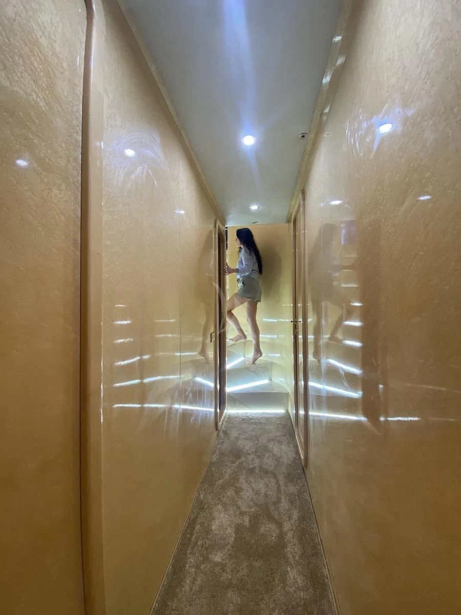 a person standing in a hallway aboard WISH Yacht for Sale