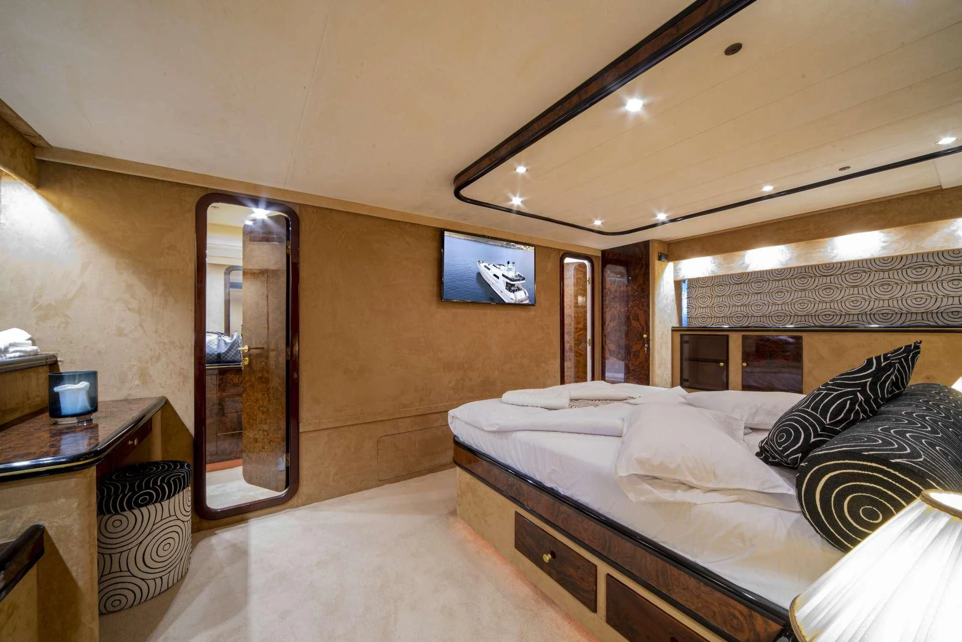 a bedroom with a bed and a mirror aboard WISH Yacht for Sale