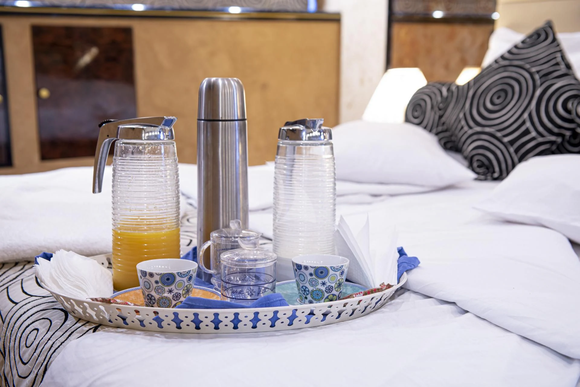 a table with a plate of food and a glass of orange juice aboard WISH Yacht for Sale