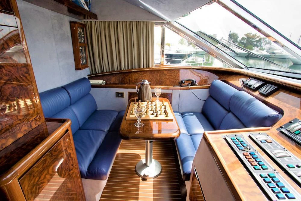 a living room with a couch and a coffee table aboard WISH Yacht for Sale