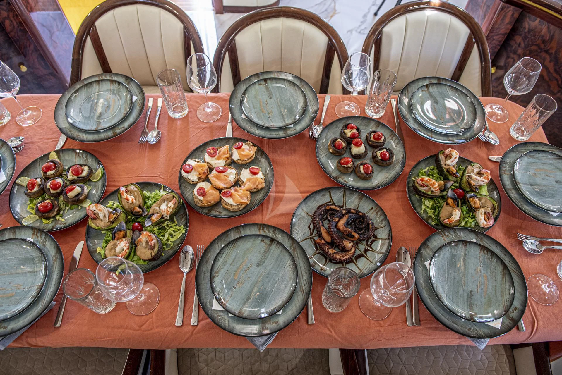a table with many dishes on it aboard WISH Yacht for Sale