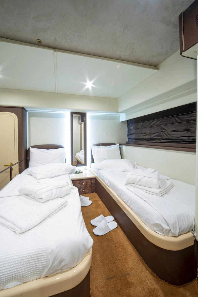 a room with two beds aboard WISH Yacht for Sale