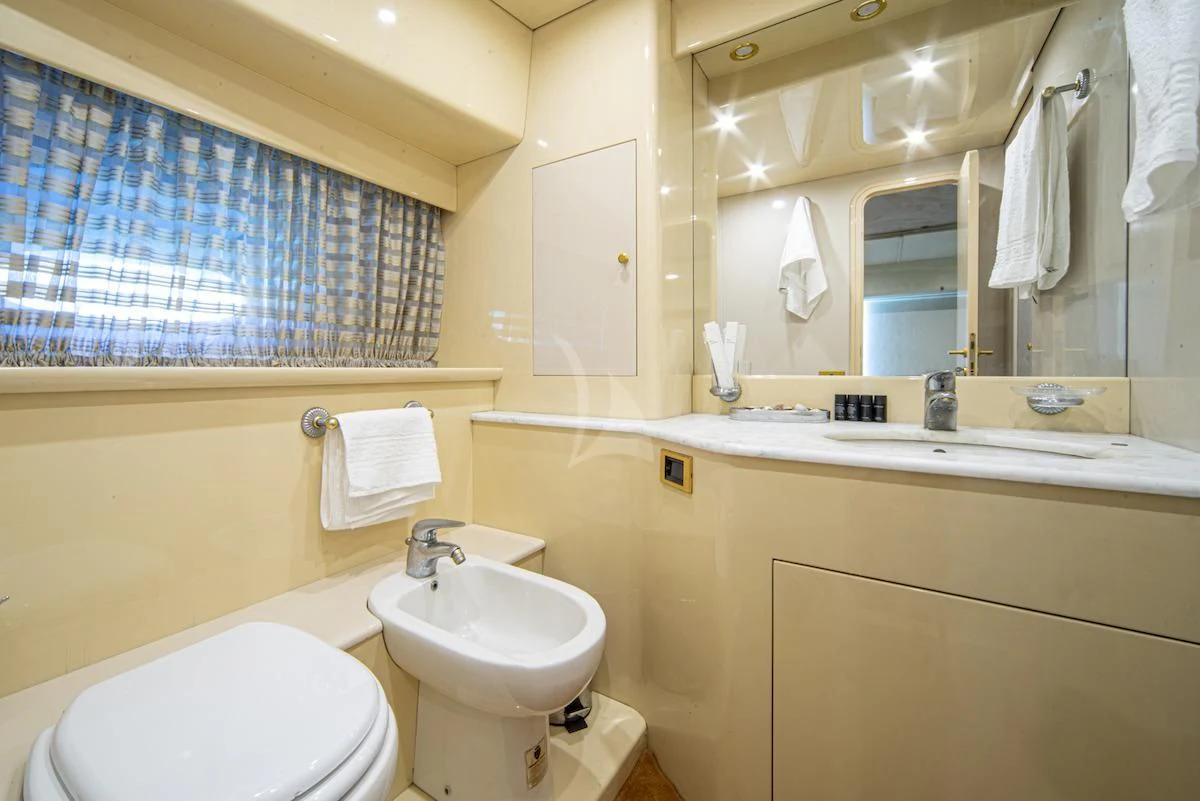 a bathroom with a sink toilet and a mirror aboard WISH Yacht for Sale