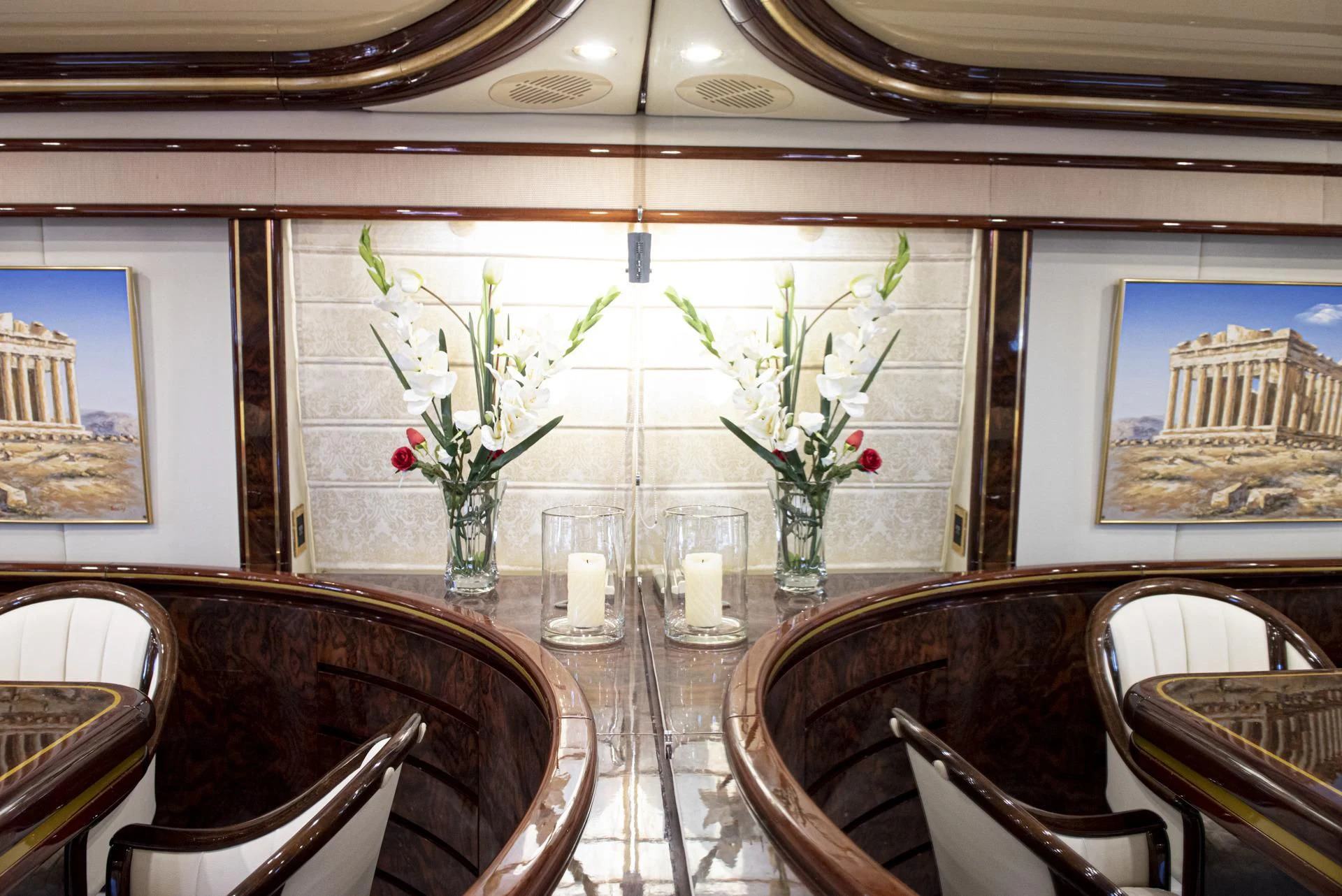 a table with vases of flowers aboard WISH Yacht for Sale