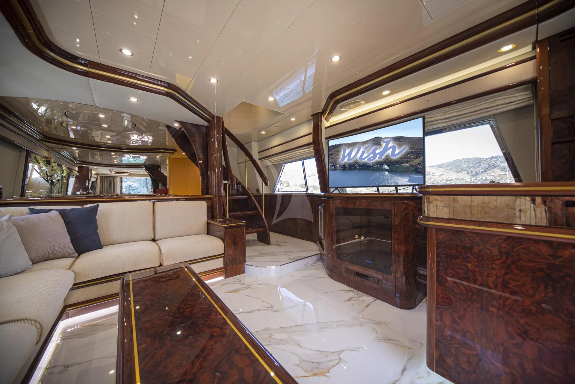 a living room with a large fireplace aboard WISH Yacht for Sale