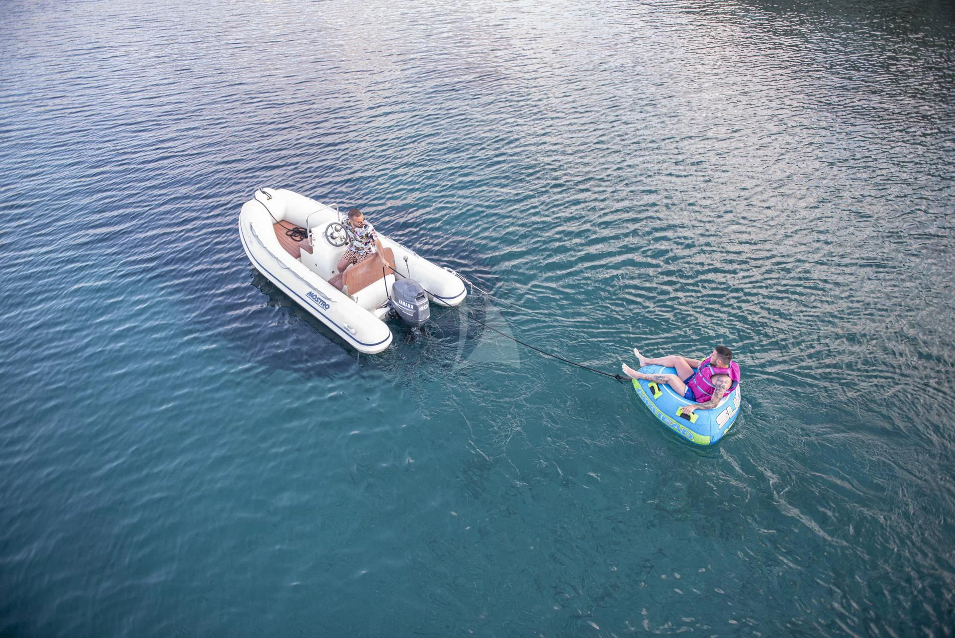 a man and a woman on a jet ski in the water aboard WISH Yacht for Sale