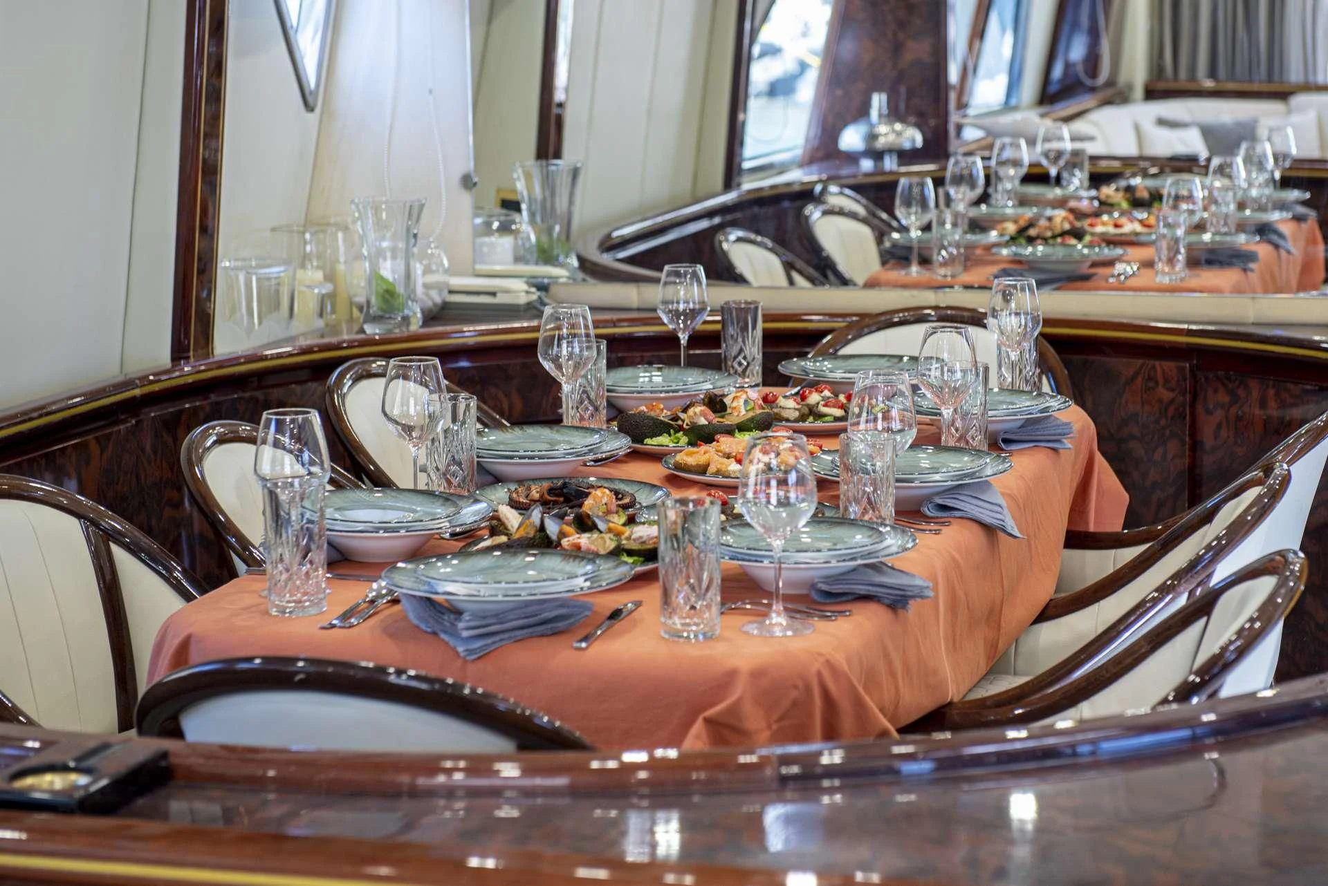 a table with plates and glasses aboard WISH Yacht for Sale