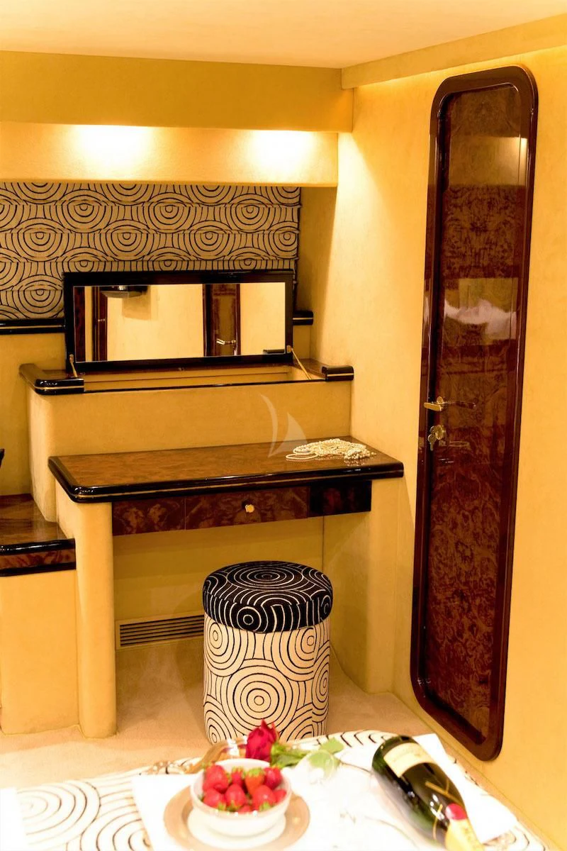 a piano with a mirror above it aboard WISH Yacht for Sale