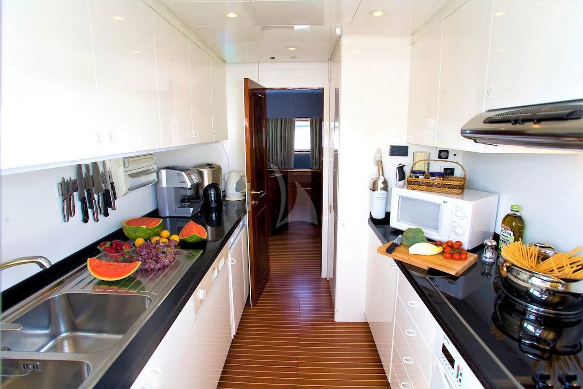 a kitchen with a sink and a microwave aboard WISH Yacht for Sale