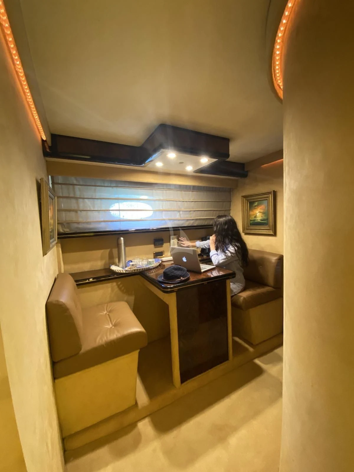 a person sitting at a desk aboard WISH Yacht for Sale