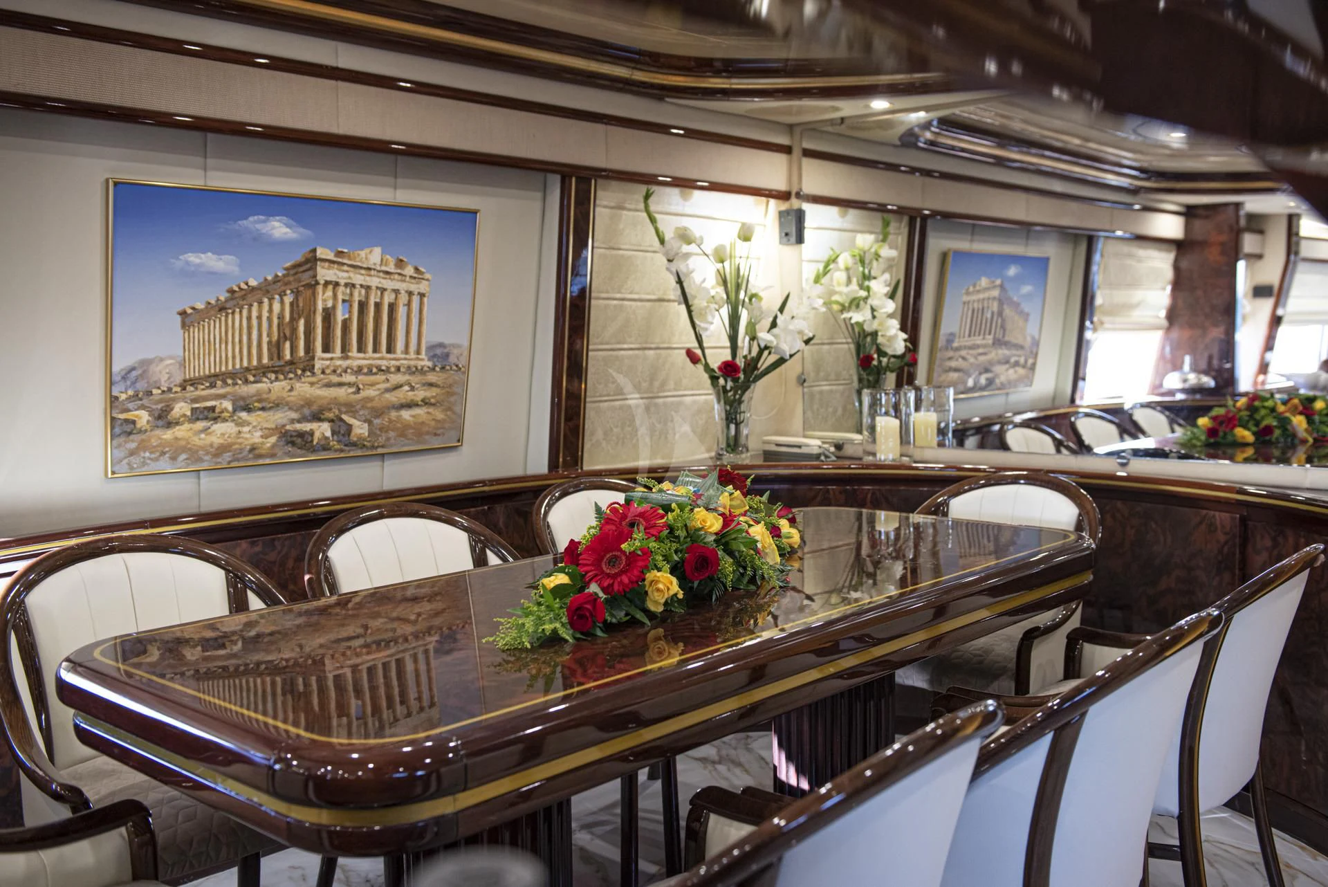 a dining table with flowers aboard WISH Yacht for Sale