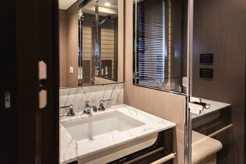 a bathroom with a sink and a mirror aboard TAMUSIA Yacht for Sale