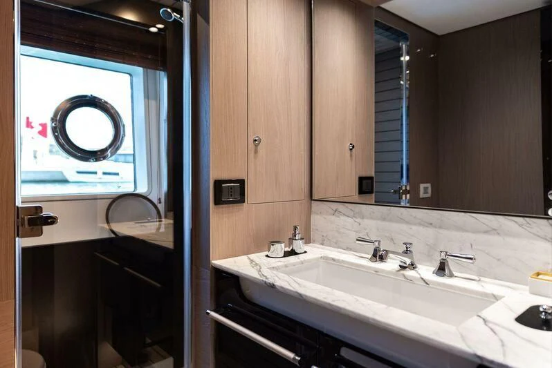 a bathroom with a sink and a mirror aboard TAMUSIA Yacht for Sale