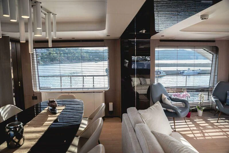 a room with a table chairs and a window aboard TAMUSIA Yacht for Sale