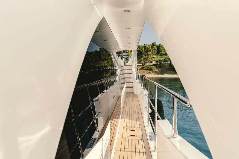 a long wooden staircase aboard TAMUSIA Yacht for Sale