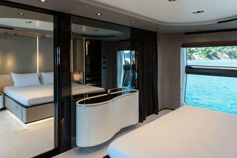 a room with a bed and a window aboard TAMUSIA Yacht for Sale