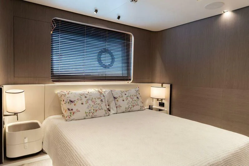 a bed with a white sheet and pillows aboard TAMUSIA Yacht for Sale