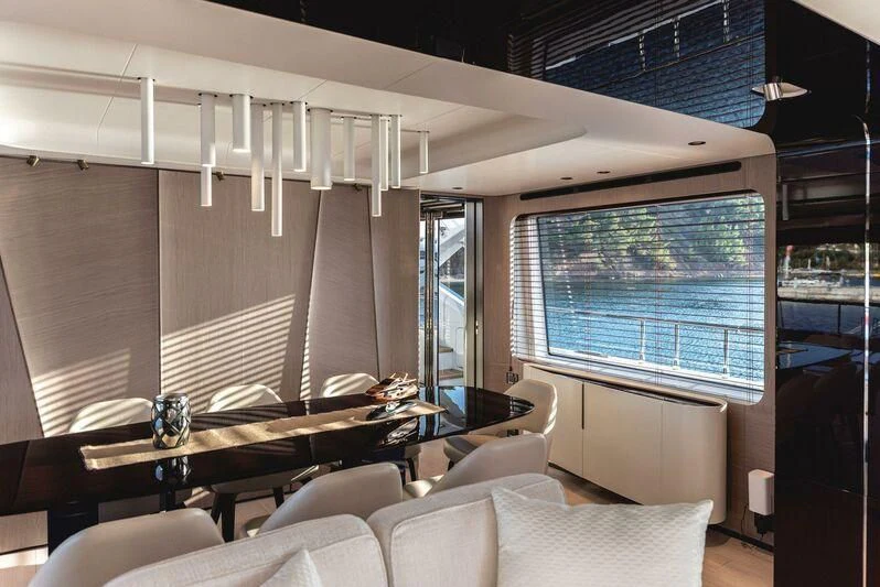 a room with a couch and a table and a window aboard TAMUSIA Yacht for Sale