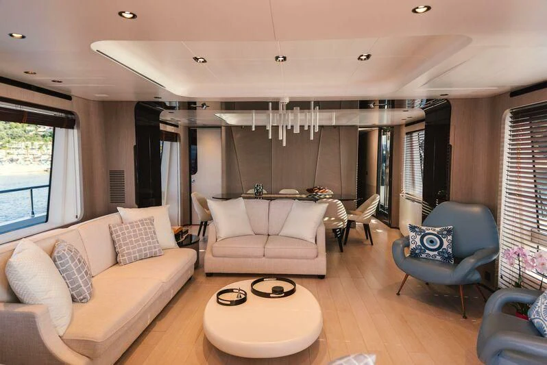 a living room with a couch and a table aboard TAMUSIA Yacht for Sale