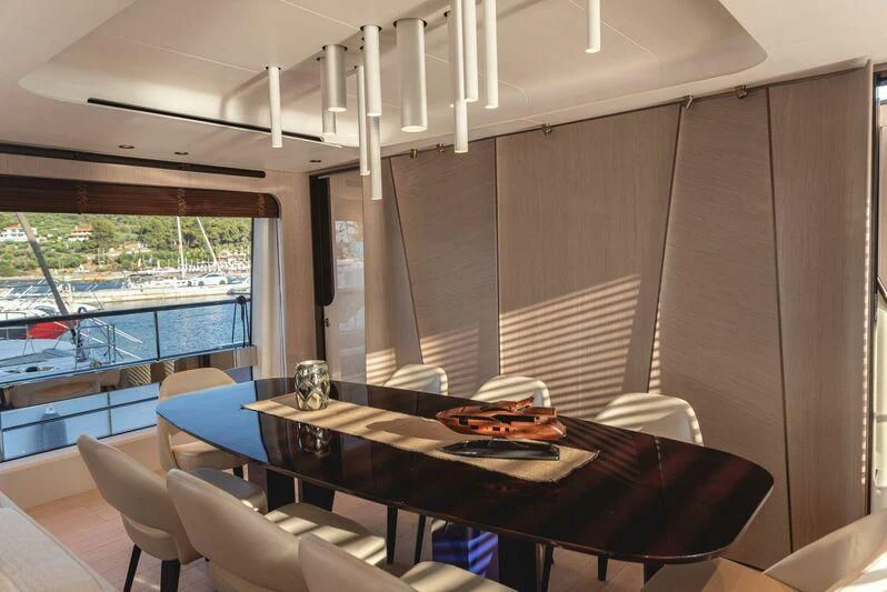 a table with chairs around it aboard TAMUSIA Yacht for Sale
