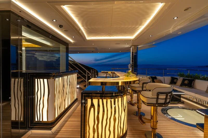 a room with a balcony and a pool aboard LEONA Yacht for Sale