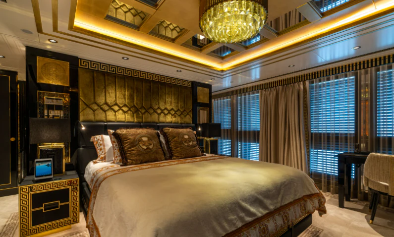 a bedroom with a bed and a window aboard LEONA Yacht for Sale