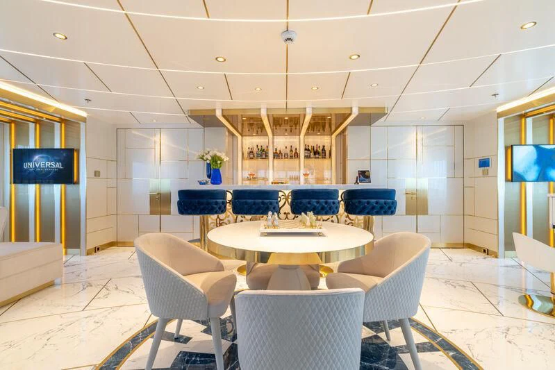 a room with a table and chairs aboard LEONA Yacht for Sale