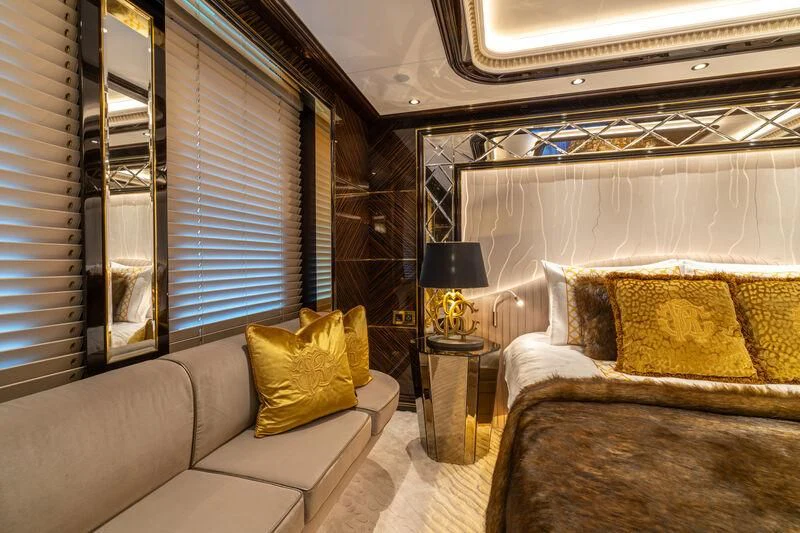 a living room with a couch and a window aboard LEONA Yacht for Sale