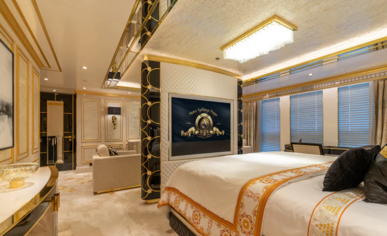a bedroom with a bed and a painting on the wall aboard LEONA Yacht for Sale